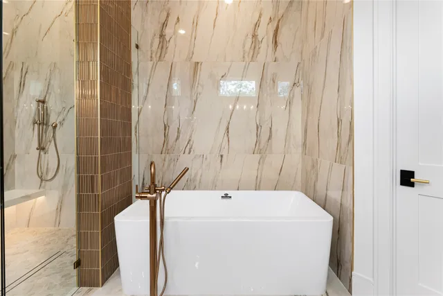 a bathroom with a bathtub and shower