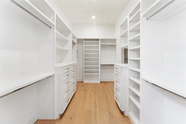 a view of walk in closet with empty racks