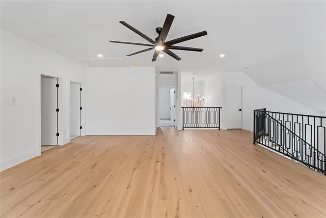 a view of a livingroom with wooden floor and a ceiling fan