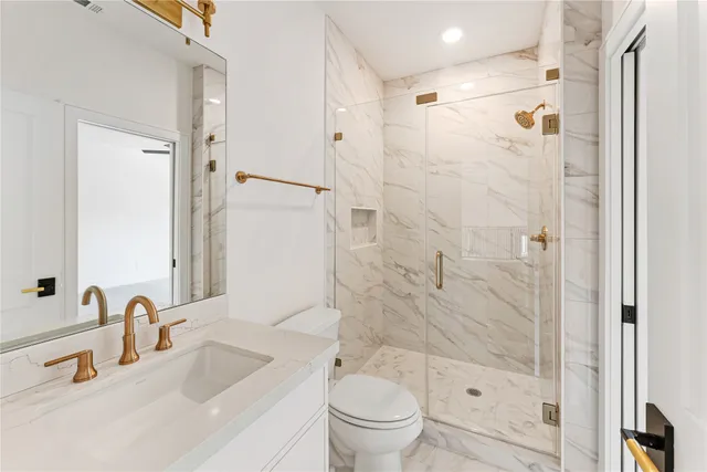 a bathroom with a sink toilet and shower