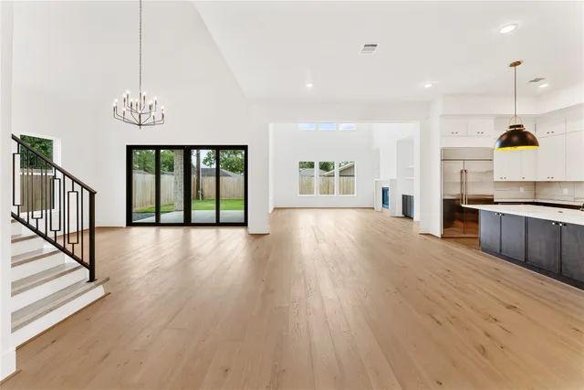 a view of a kitchen center island wooden floor and windows