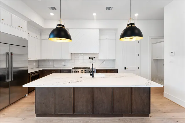 a kitchen with a sink a stove a refrigerator and a stove