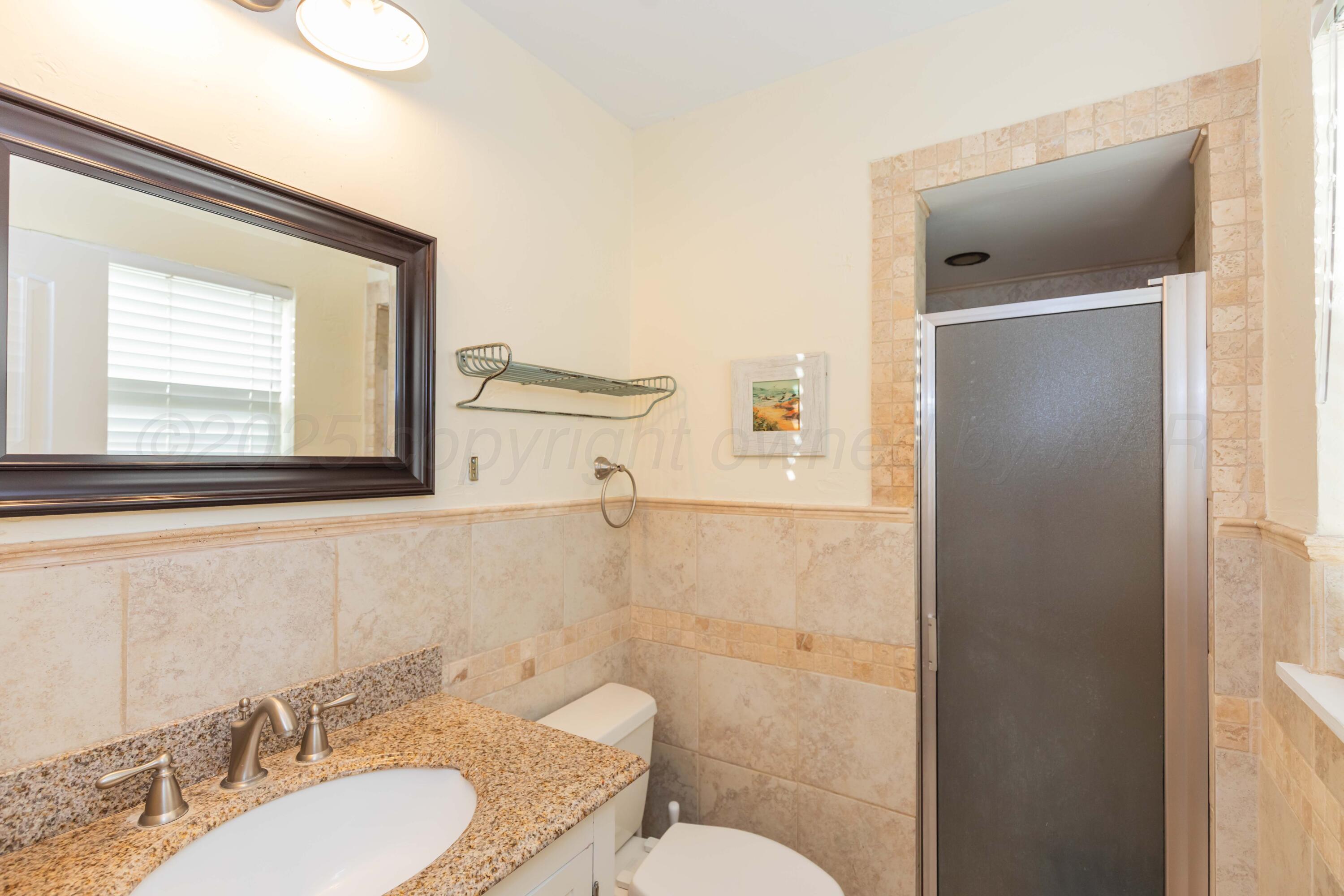 Amarillo Sunset Portfolio Amarillo, TX 79109 - Photo 136 of 279 a bathroom with a granite countertop sink toilet a mirror and shower