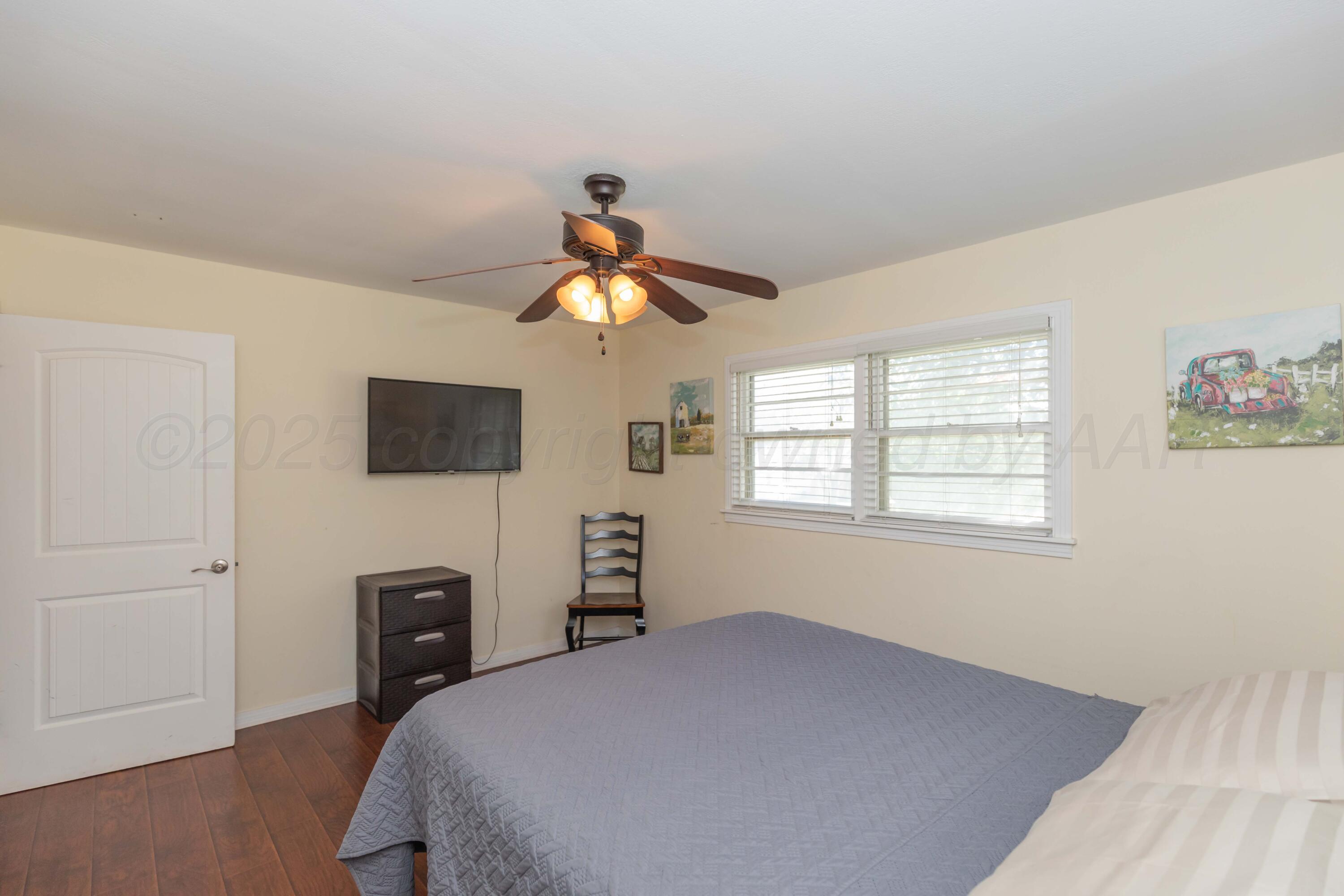 Amarillo Sunset Portfolio Amarillo, TX 79109 - Photo 222 of 279 a bedroom with a bed and a chandelier