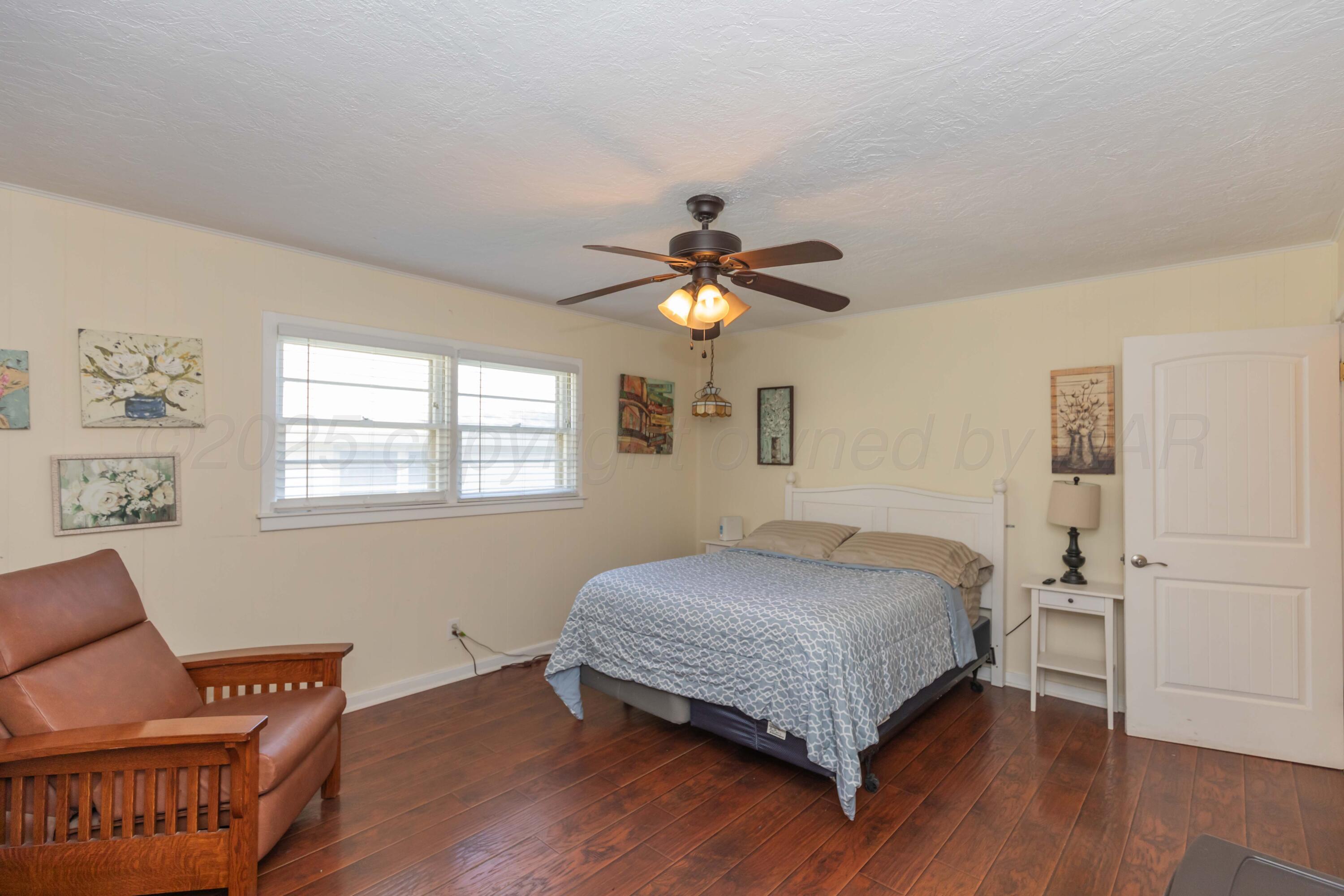 Amarillo Sunset Portfolio Amarillo, TX 79109 - Photo 243 of 279 a bedroom with a bed and wooden floor