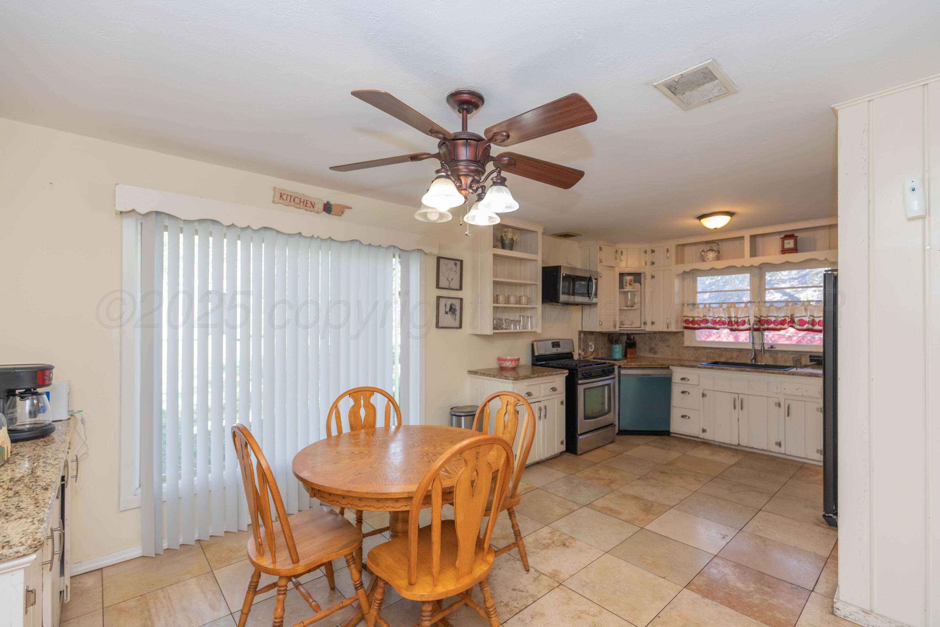 Amarillo Sunset Portfolio Amarillo, TX 79109 - Photo 260 of 279 a kitchen with stainless steel appliances granite countertop a stove top oven a sink dishwasher a dining table and chairs with wooden floor