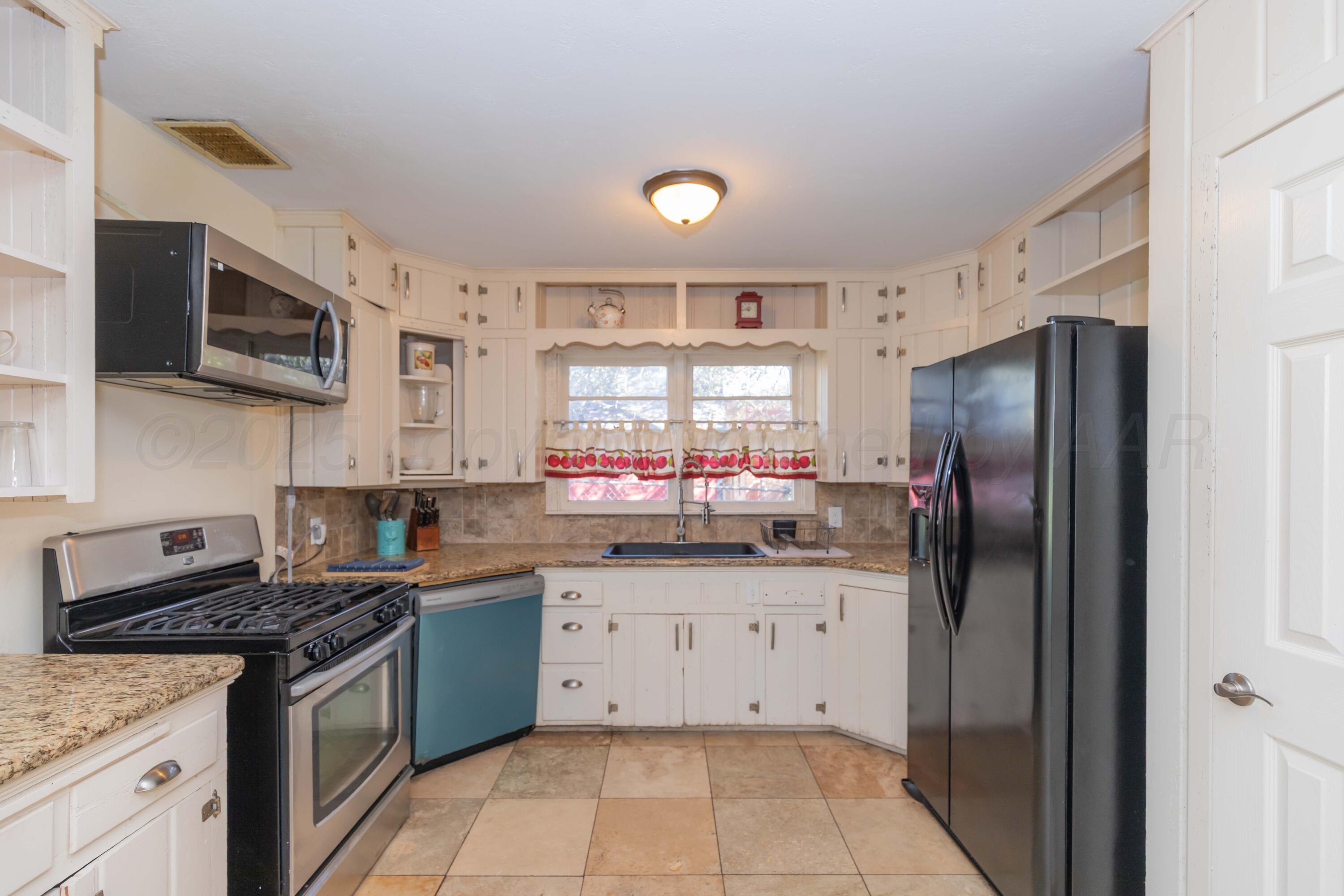Amarillo Sunset Portfolio Amarillo, TX 79109 - Photo 261 of 279 a kitchen with stainless steel appliances granite countertop a stove a sink dishwasher a refrigerator and a microwave