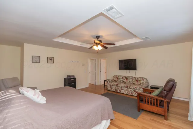 a kitchen with stainless steel appliances granite countertop a stove top oven a sink dishwasher a dining table and chairs with wooden floor