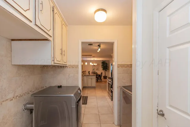 a bedroom with a bed a dresser with wooden floor
