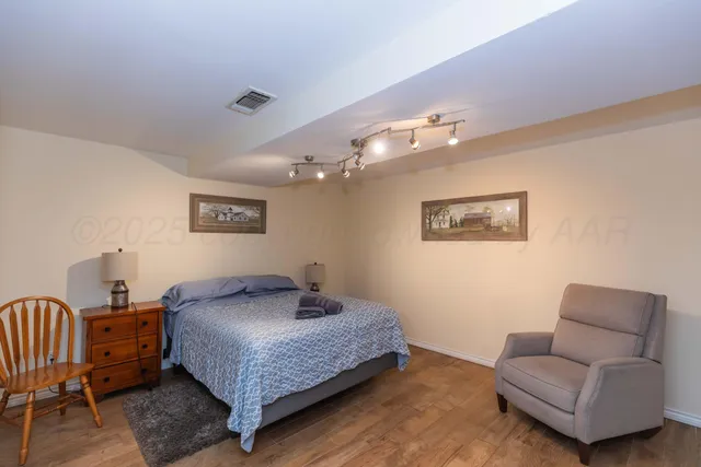a view of a dining room with furniture wooden floor and chandelier