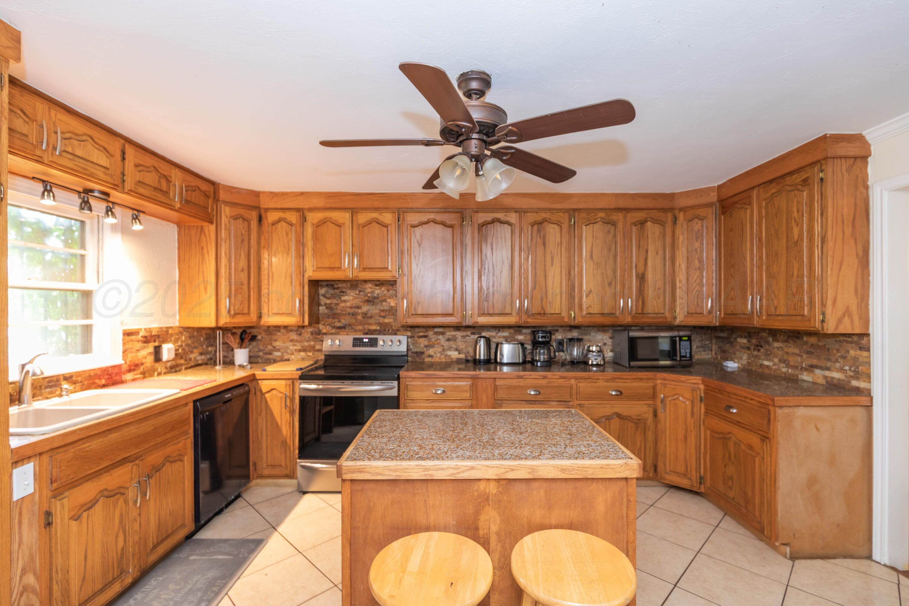 Amarillo Sunset Portfolio Amarillo, TX 79109 - Photo 75 of 279 a kitchen with a sink a stove cabinets and a window