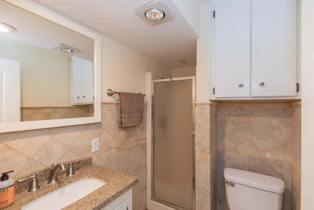 a bedroom with bed and a chandelier