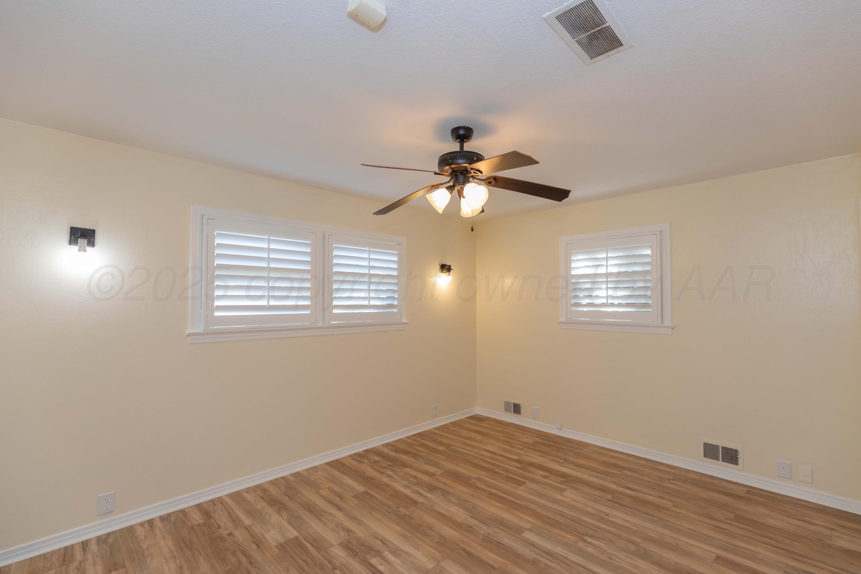Amarillo Sunset Portfolio Amarillo, TX 79109 - Photo 86 of 279 a view of empty room with wooden floor and fan