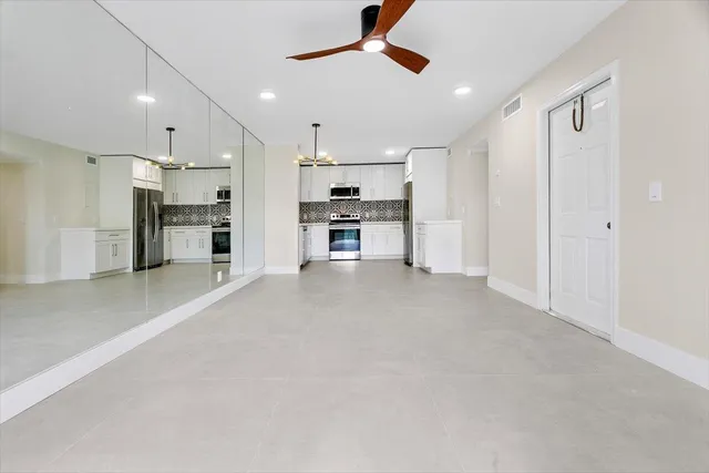 a view of a kitchen with a sink and stainless steel appliances