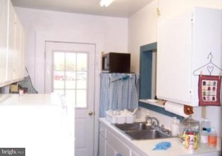 15770 Bassford Road Waldorf, MD 20601 - Photo 11 of 16 a bathroom with a sink a flat screen tv and a window