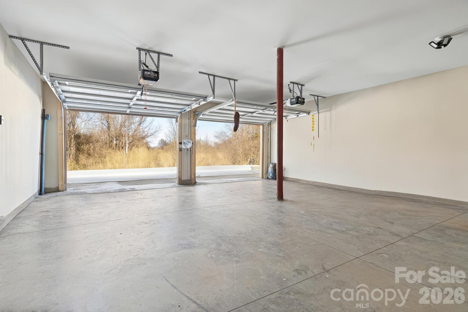 5961 Charlie Little Road Granite Falls, NC 28630 - Photo 26 of 29 a view of empty room with wooden floor and windows