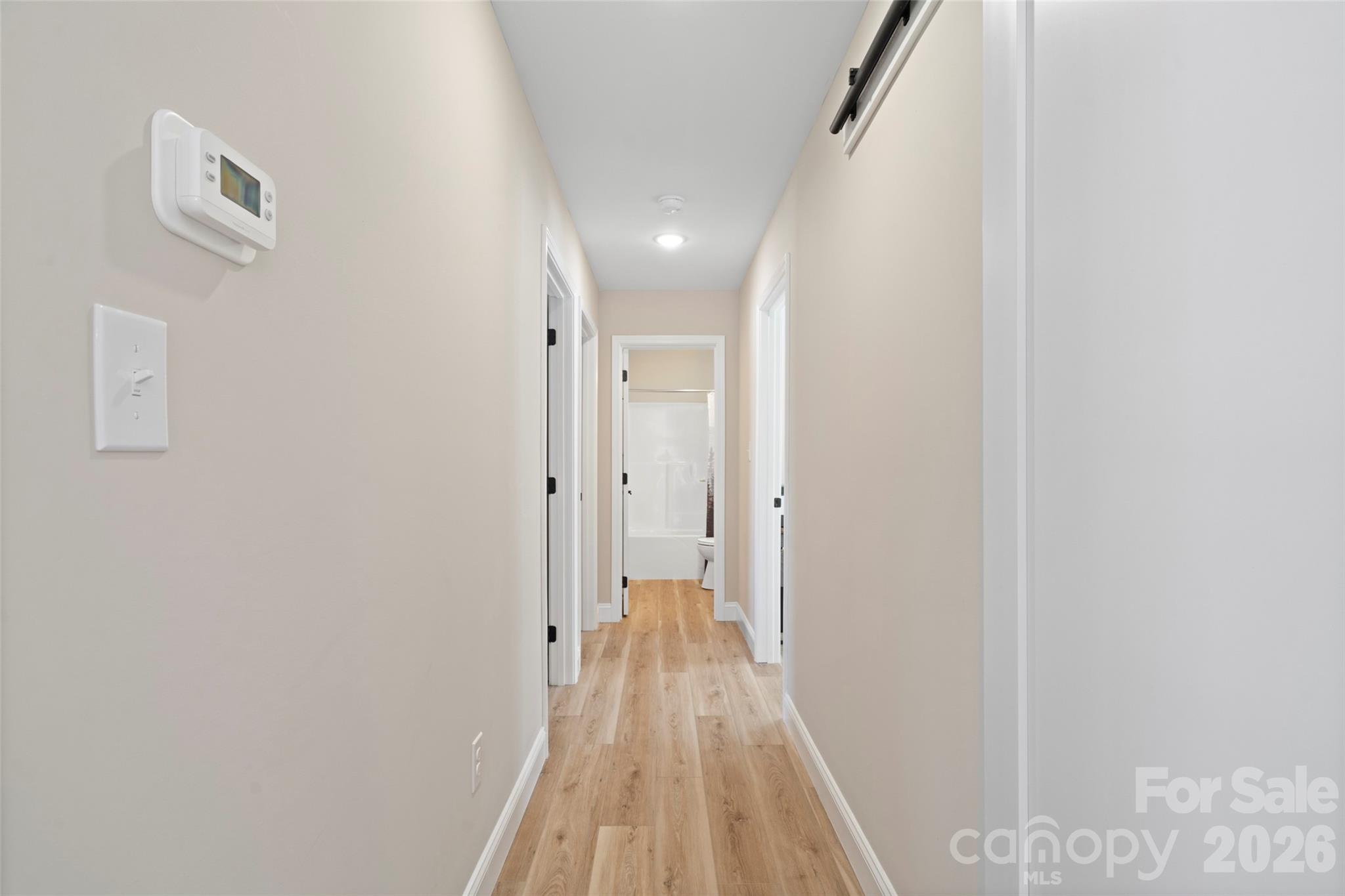 5961 Charlie Little Road Granite Falls, NC 28630 - Photo 8 of 29 a view of a hallway with wooden floor and a bathroom