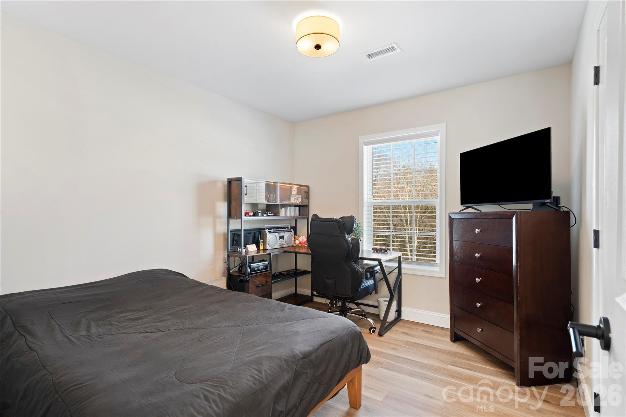 5961 Charlie Little Road Granite Falls, NC 28630 - Photo 9 of 29 a bedroom with a bed and a flat screen tv