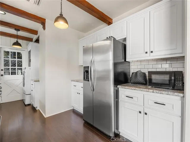 a view of a house with a small yard and a tub
