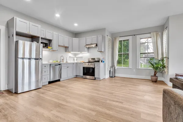 a kitchen with stainless steel appliances granite countertop a refrigerator oven a sink and dishwasher