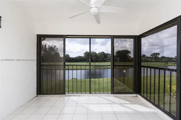 a view of entryway with a floor to ceiling window and a ceiling fan