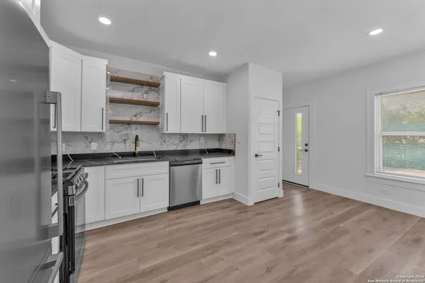 a kitchen with a sink a microwave and cabinets