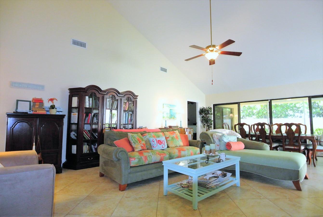 200 Ridge Road Jupiter, FL 33477 - Photo 4 of 18 a living room with furniture a flat screen tv and a window