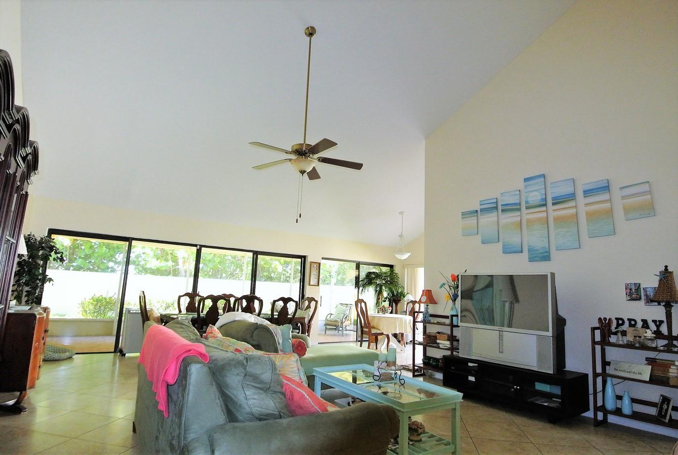 200 Ridge Road Jupiter, FL 33477 - Photo 7 of 18 a living room with furniture and a floor to ceiling window