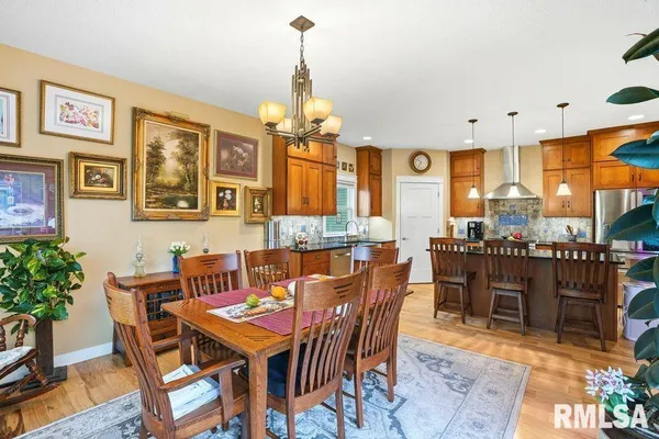 a dining room with furniture a chandelier and window