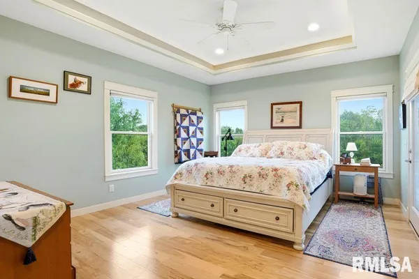 a white bed sitting in a bedroom next to a window