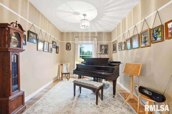 a living room with furniture a piano and a window