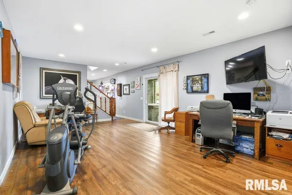 a view of a livingroom with workspace and a couch