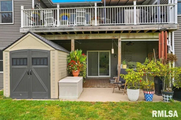 a view of a chair and table in back yard of the house