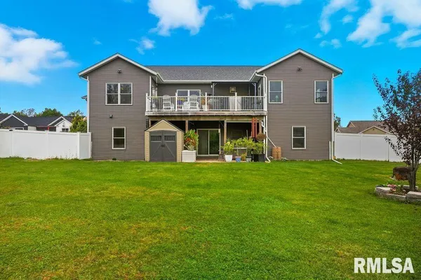 a view of a house with a yard and sitting area