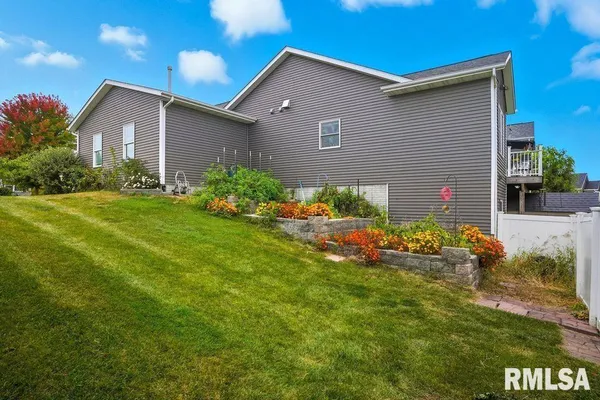 a front view of house with a garden