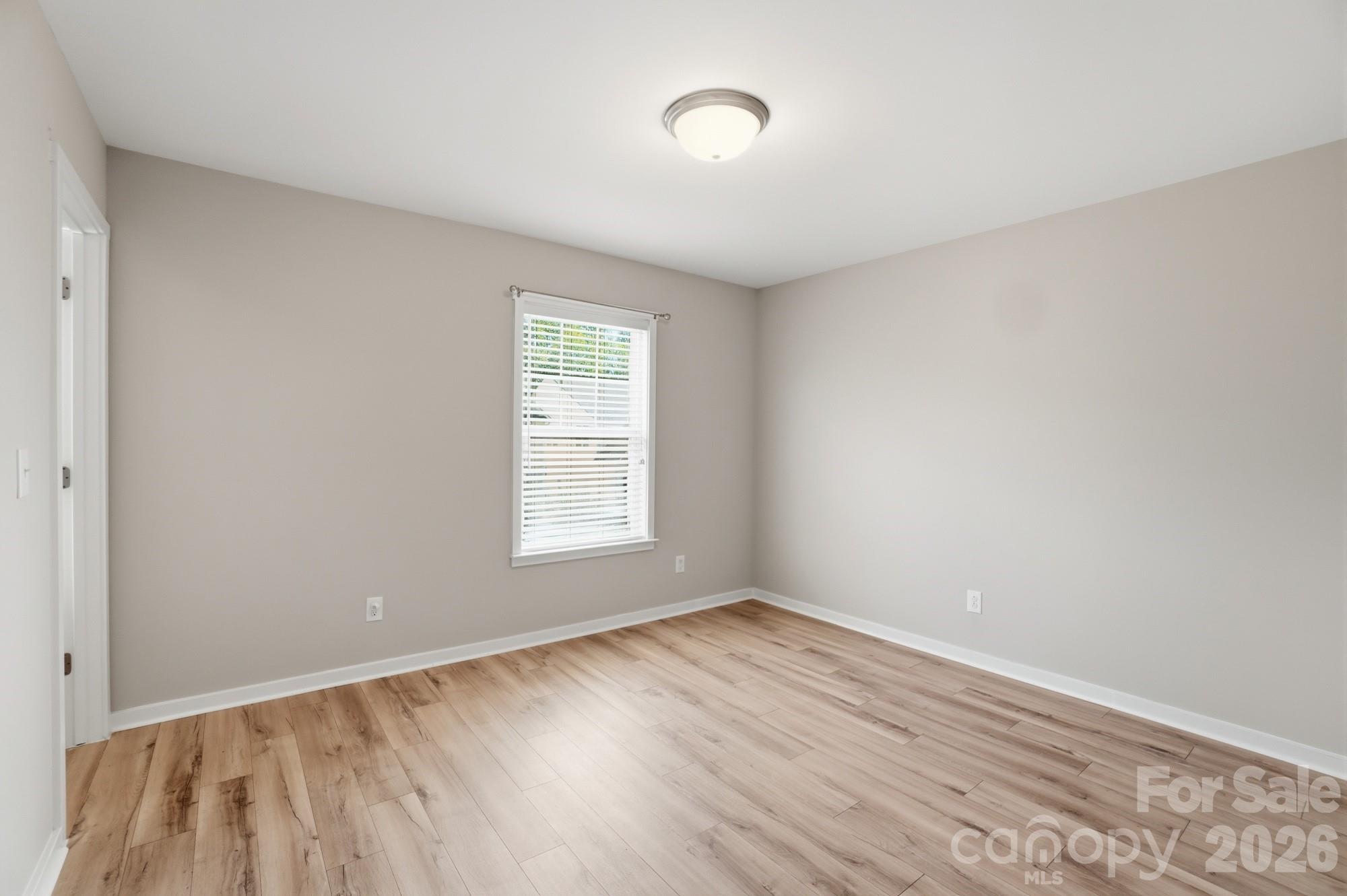2153 Bluebell Way Tega Cay, SC 29708 - Photo 36 of 48 an empty room with wooden floor and windows