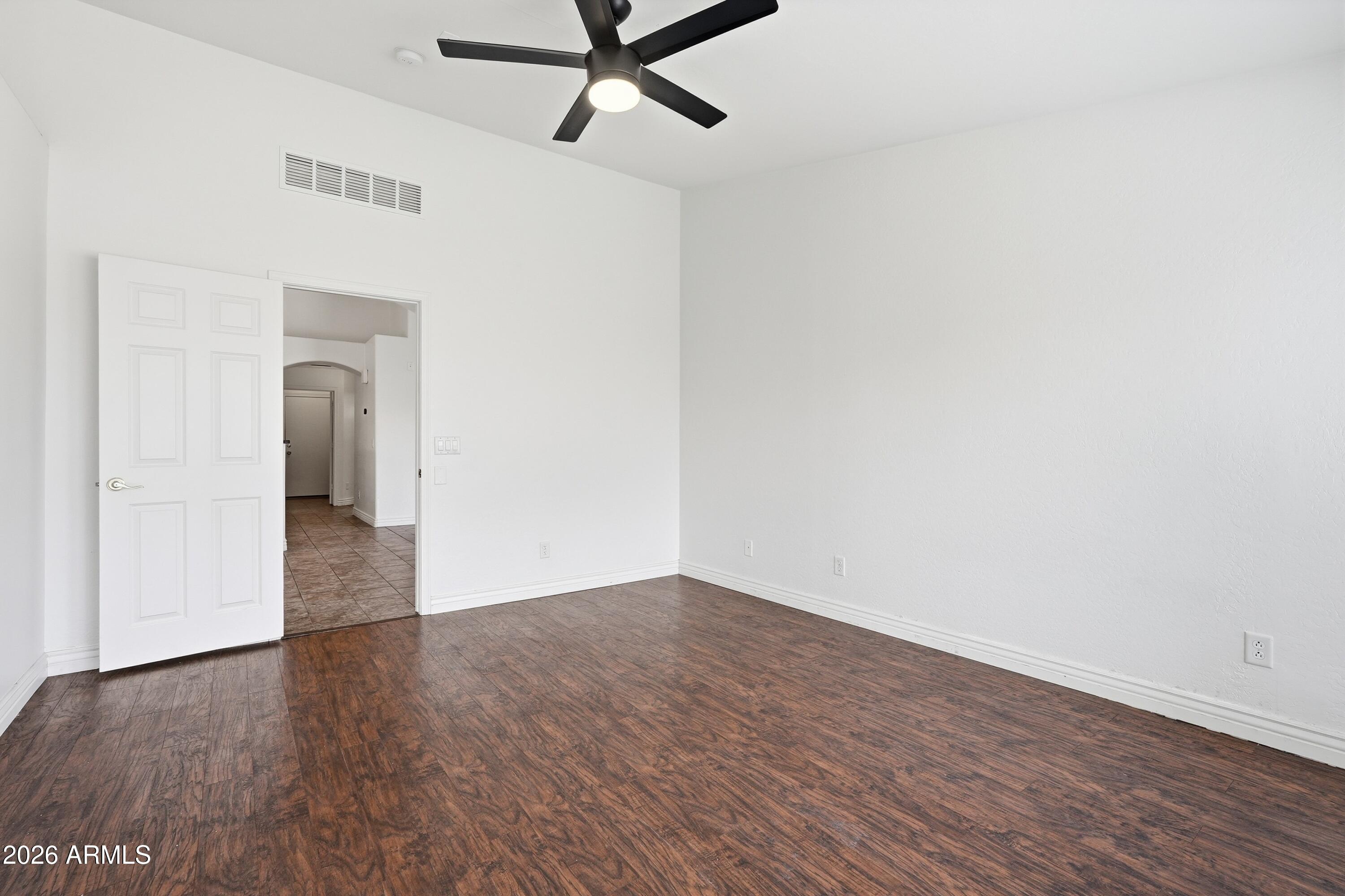 3242 East Bonanza Road Gilbert, AZ 85297 - Photo 16 of 36 a view of a room with wooden floor and white walls