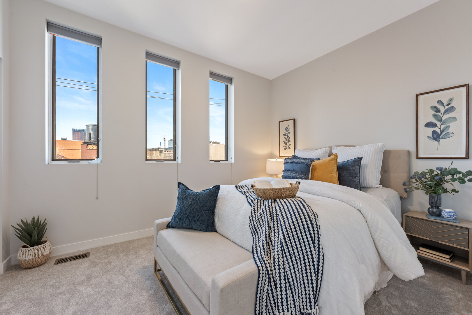 1236 West Cottage Place, Unit 1236 Chicago, IL 60607 - Photo 18 of 24 a bedroom with a large bed and a potted plant