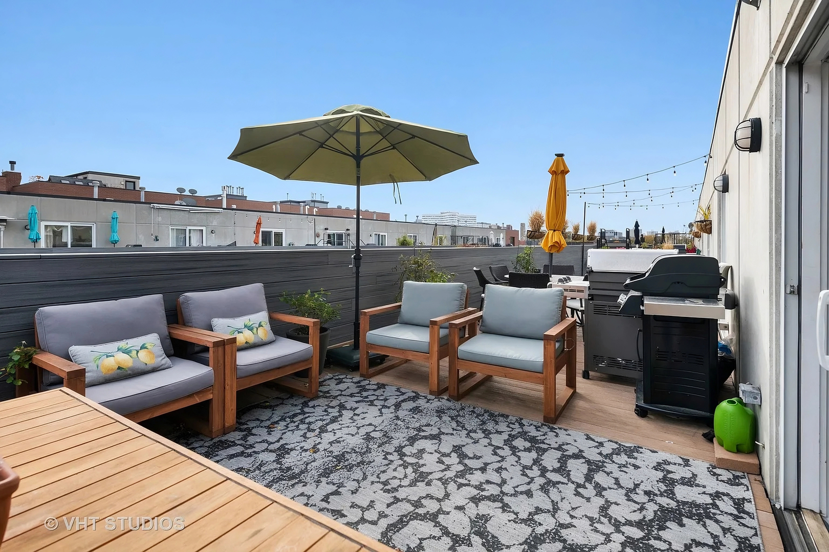 1236 West Cottage Place, Unit 1236 Chicago, IL 60607 - Photo 23 of 24 a view of a terrace with furniture and umbrella