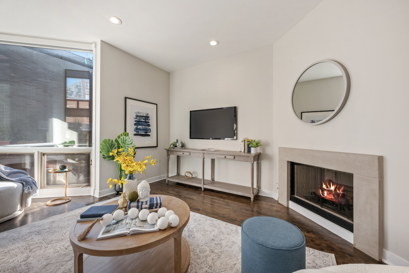 1236 West Cottage Place, Unit 1236 Chicago, IL 60607 - Photo 4 of 24 a living room with furniture a fireplace and a flat screen tv
