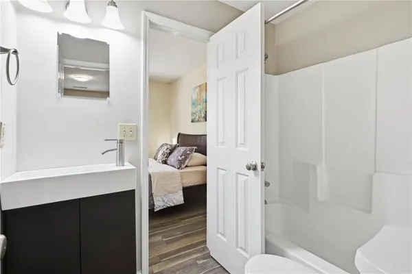 a bathroom with a sink toilet and shower