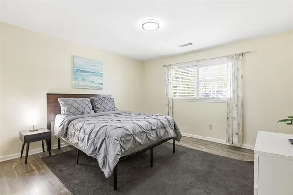 a bed sitting in a bedroom next to a window