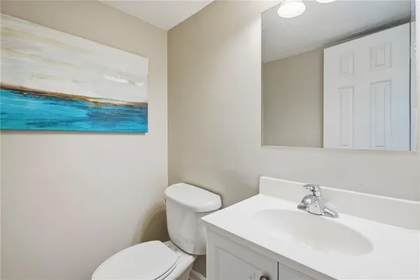 a bathroom with a sink a toilet and mirror