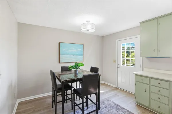 a view of a dining room with furniture and a window