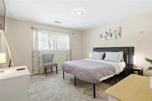 a spacious bedroom with a bed and window