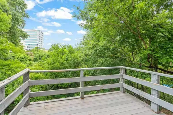 a view of deck with seating and trees