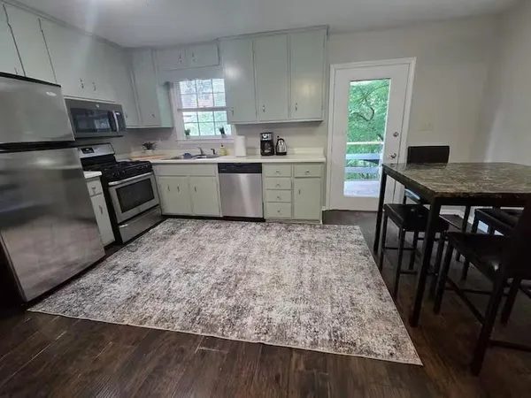 a kitchen with a stove a sink and a refrigerator