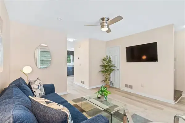a living room with furniture and a flat screen tv