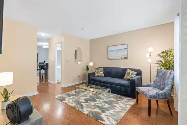 a living room with furniture and a rug