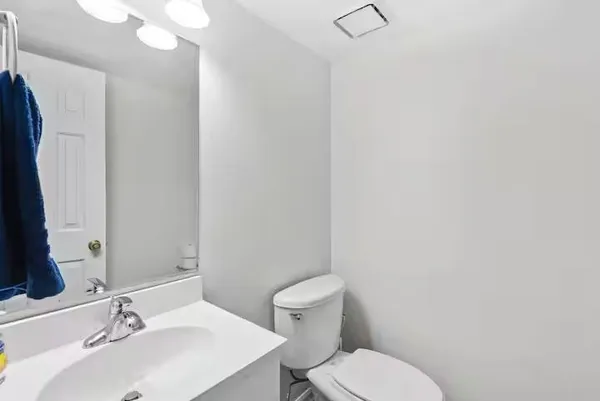 a bathroom with a sink vanity mirror and toilet